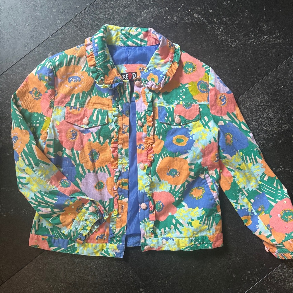 Redd Jeans floral print jacket with ruffle edges and sequin buttons